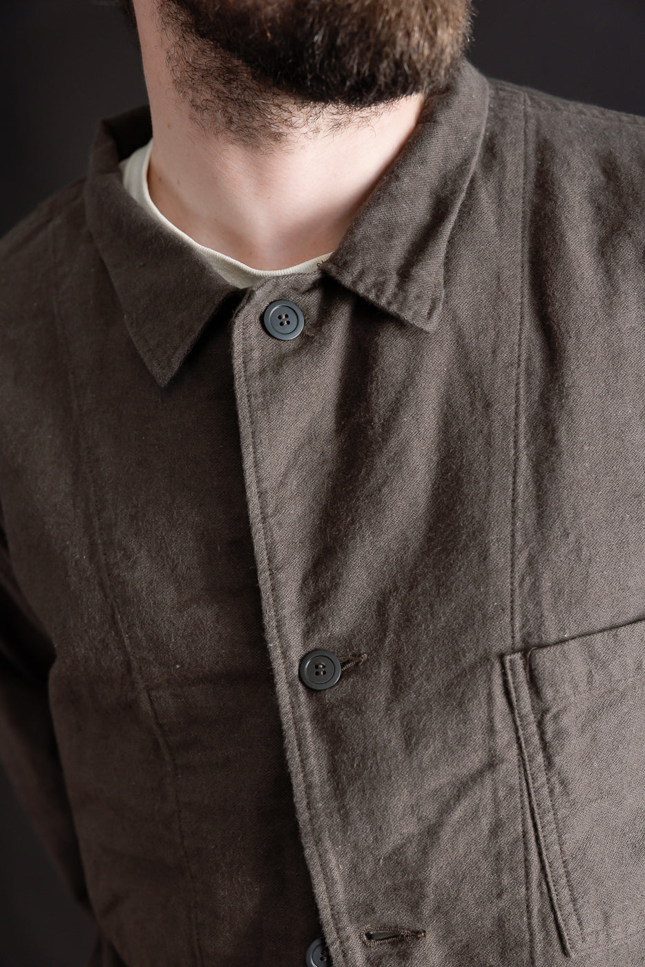 Close-up front detail of charcoal moleskin work jacket on male model, 5'9