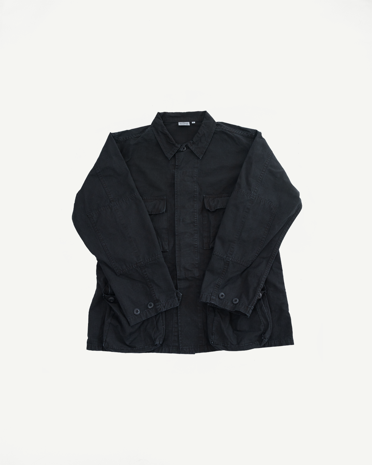 01-6110-61S - Ripstop BDU Jacket - Black Stone: A black, long-sleeved field jacket with a pointed collar, button-up front, and four patch pockets, showcasing its rugged, military-inspired design and durable Japanese ripstop fabric.