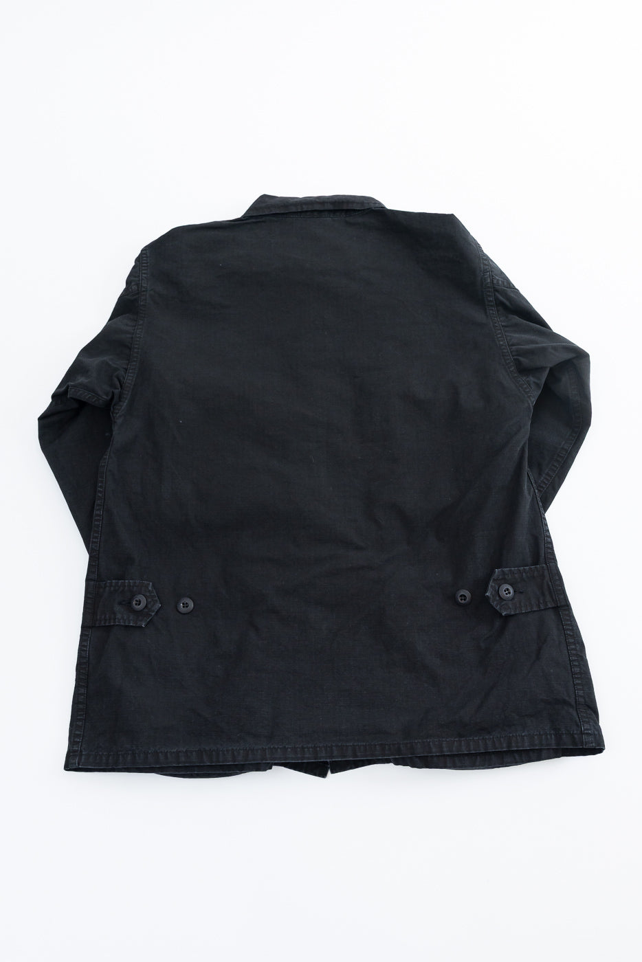 Black Ripstop BDU Jacket by orSlow, featuring a simple collar, adjustable waist tabs, and durable Japanese ripstop fabric. Styled with a military-inspired design, perfect for layering.