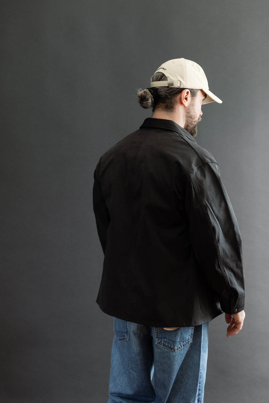 Back view of a black casual jacket on a 5'9