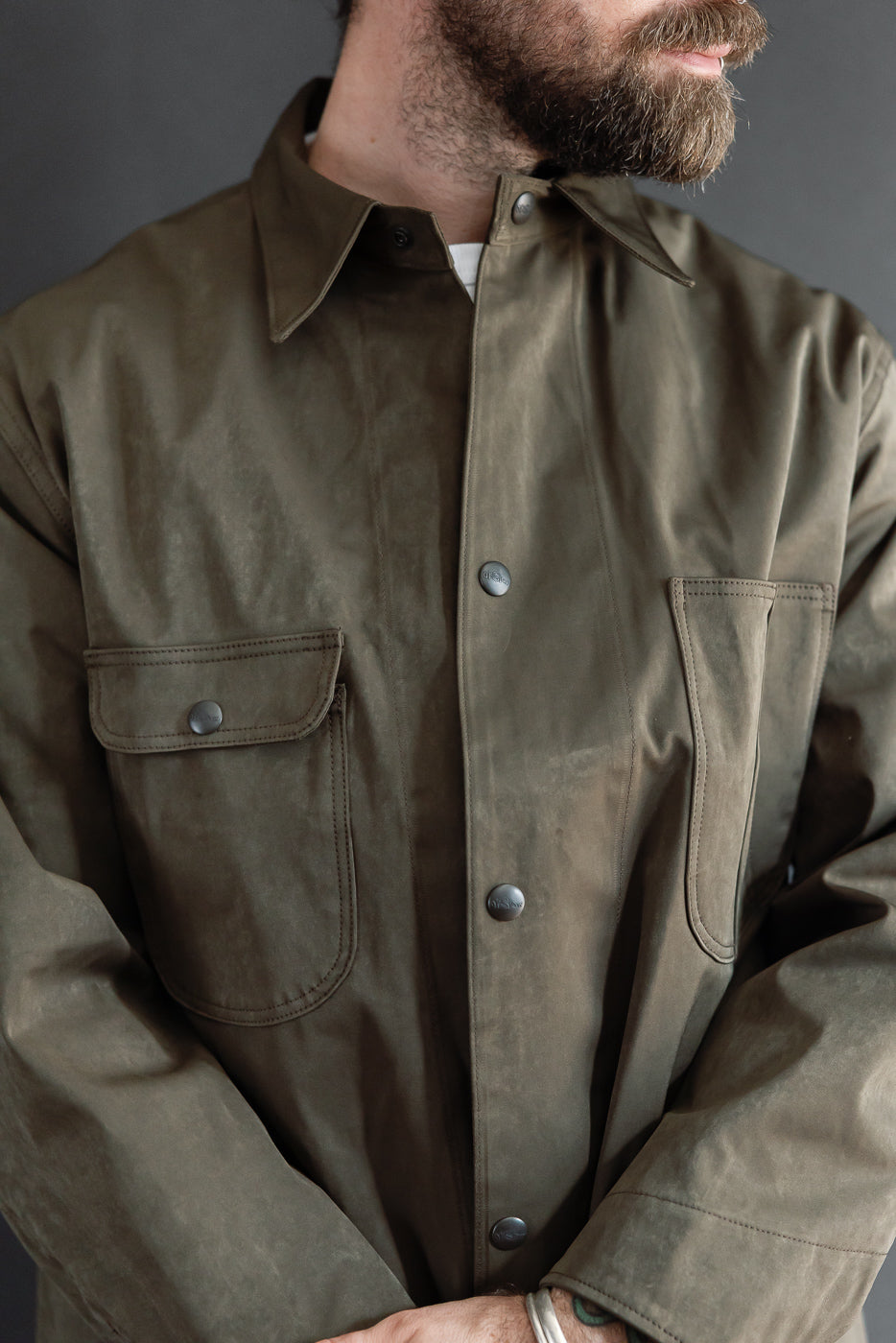 Close-up front view of olive jacket on athletic 5'9