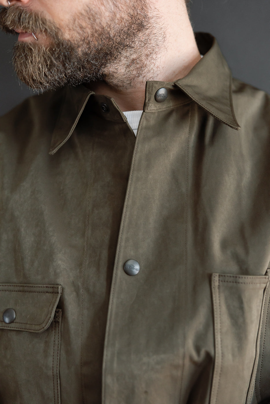Close-up front view of olive green shirt on male model, 5'9