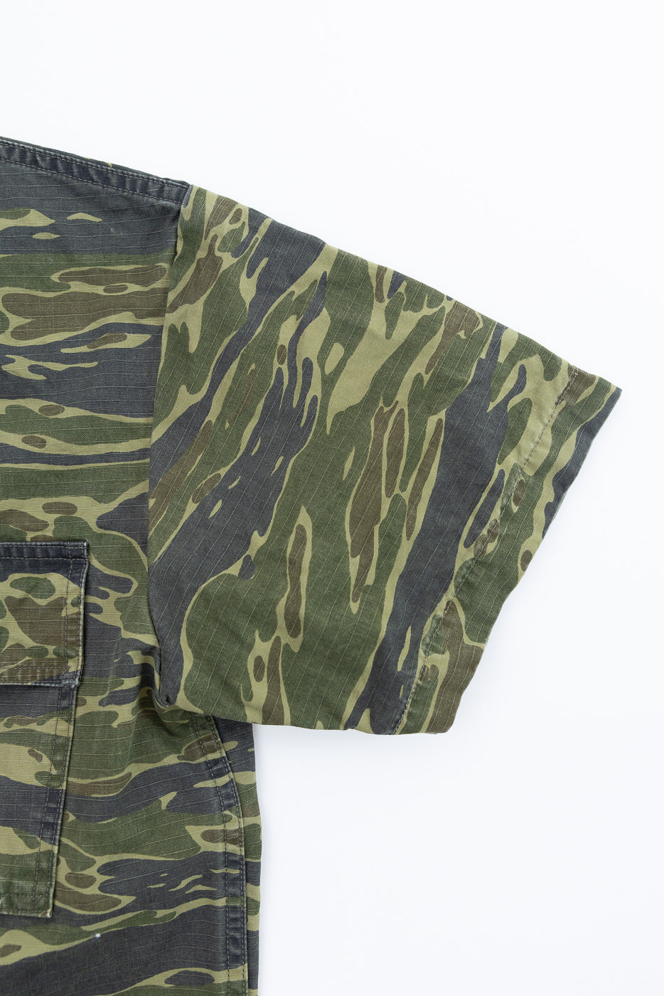 The 01-8046 -TGC - Utility Short Sleeve Work Shirt Jacket in Tiger Camo features a visible right sleeve and a patch pocket, highlighting its military-inspired, relaxed shirt-jacket silhouette.