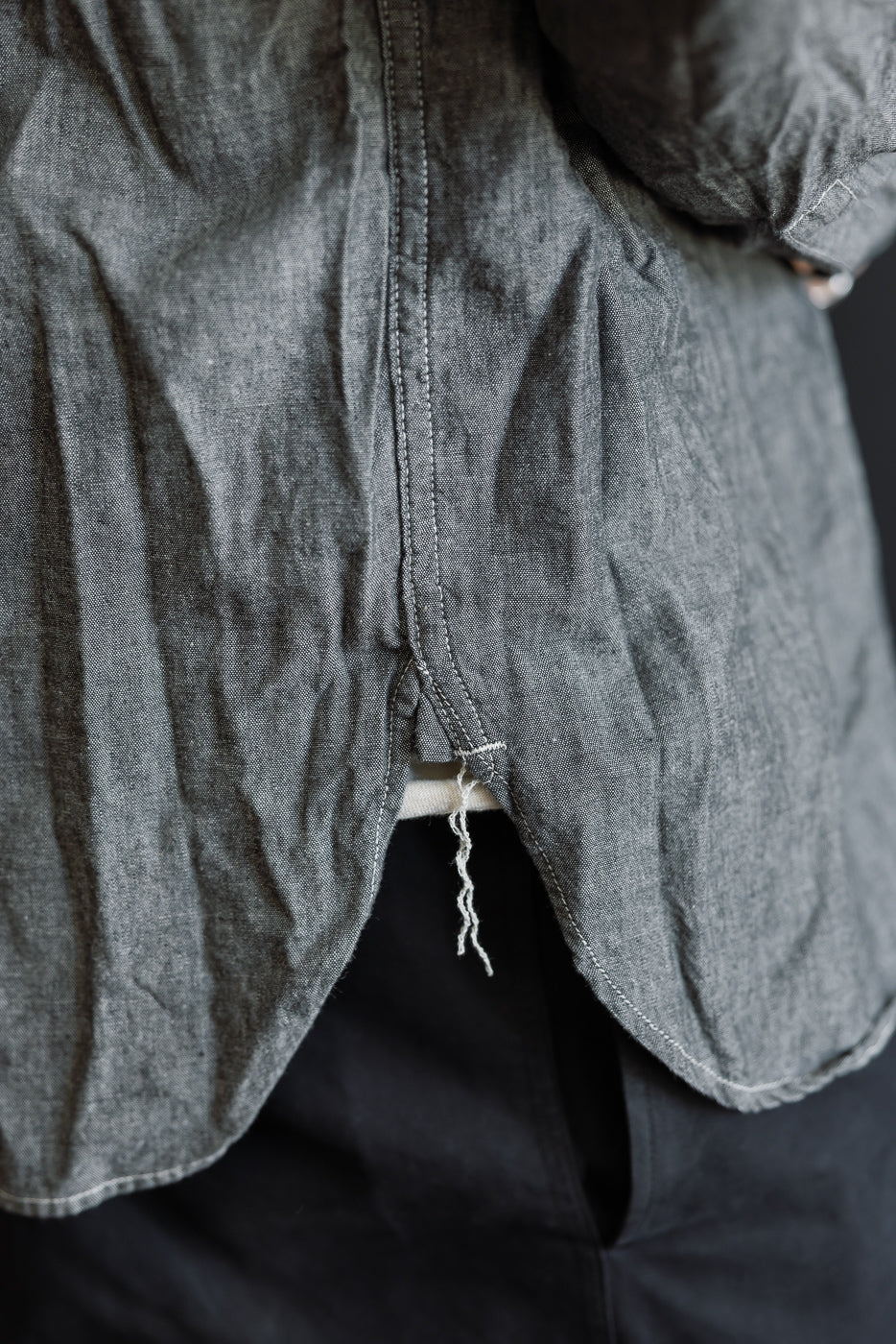 Close-up of the 01-8270-61 - Relaxed Fit Chambray Work Shirt, showcasing detailed top-stitching, frayed thread, and a classic 1940s-inspired design with a roomy silhouette, highlighting craftsmanship and heritage style.