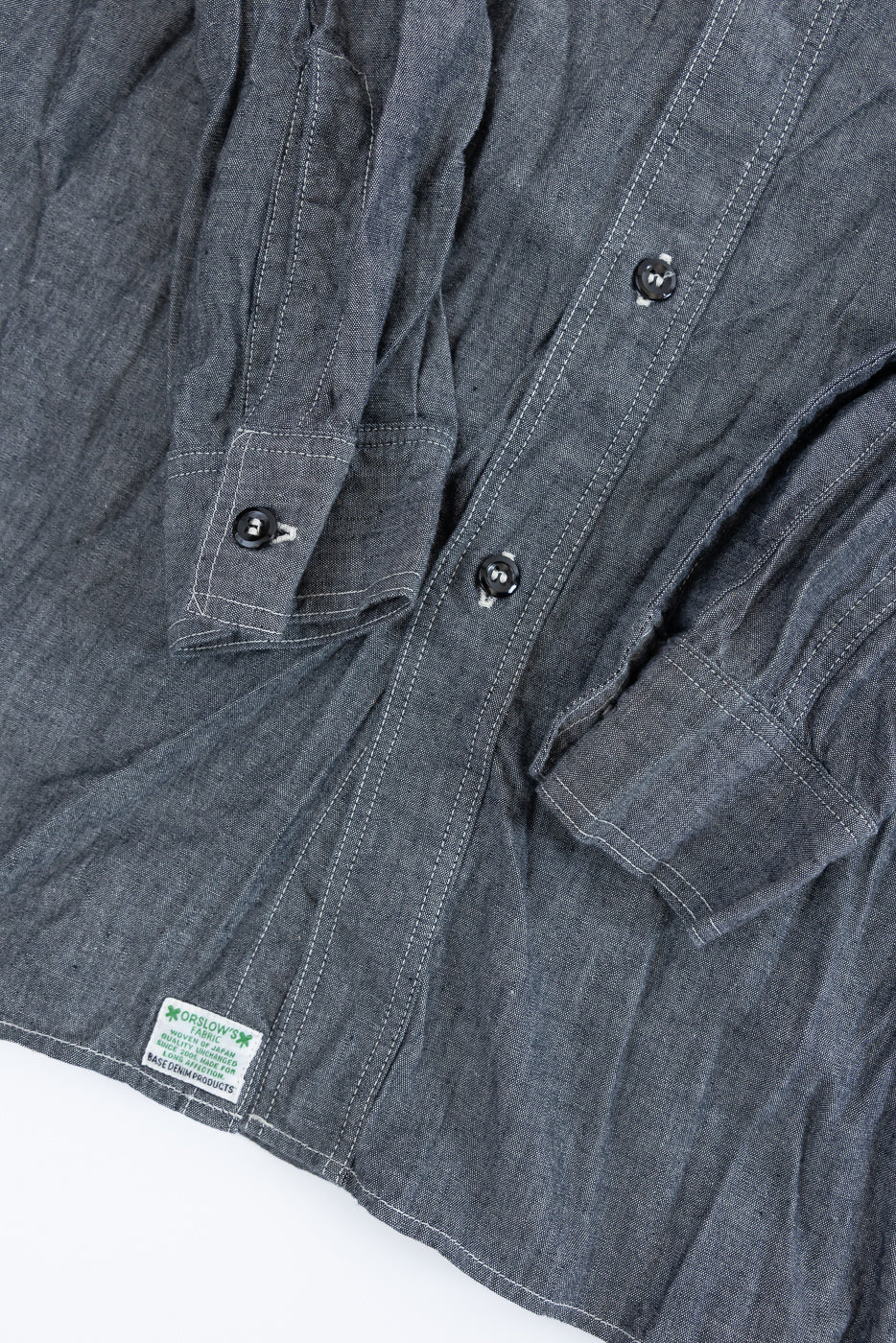 01-8270-61 - Relaxed Fit Chambray Work Shirt - Black displayed flat, showcasing its dark buttons, front placket, double-stitched seams, and woven “ORSLOW” label near the hem, embodying vintage workwear style.