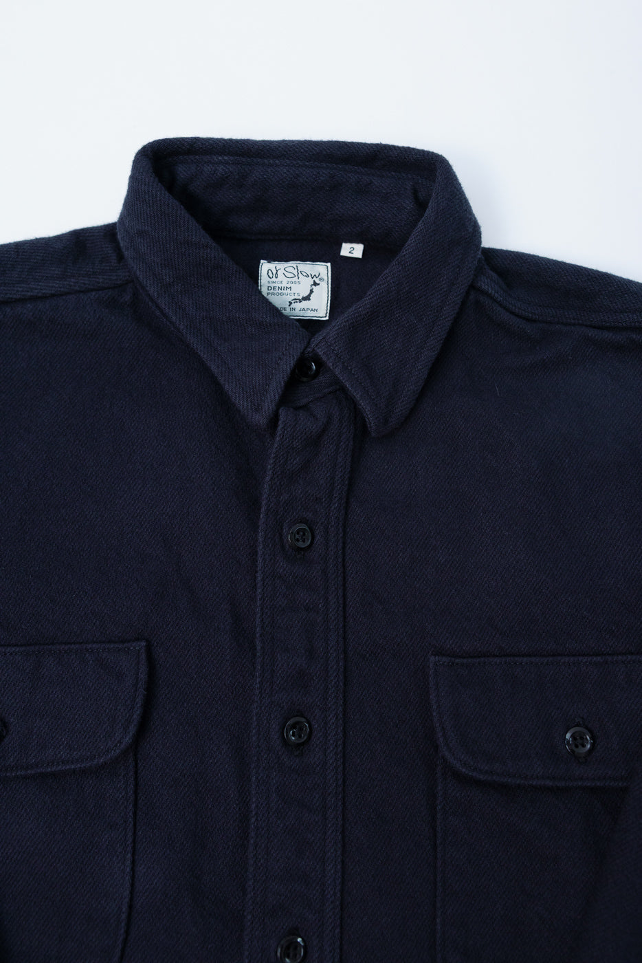 Close-up front view of Orslow navy relaxed fit flannel shirt, buttons, chest pockets, collar detail
