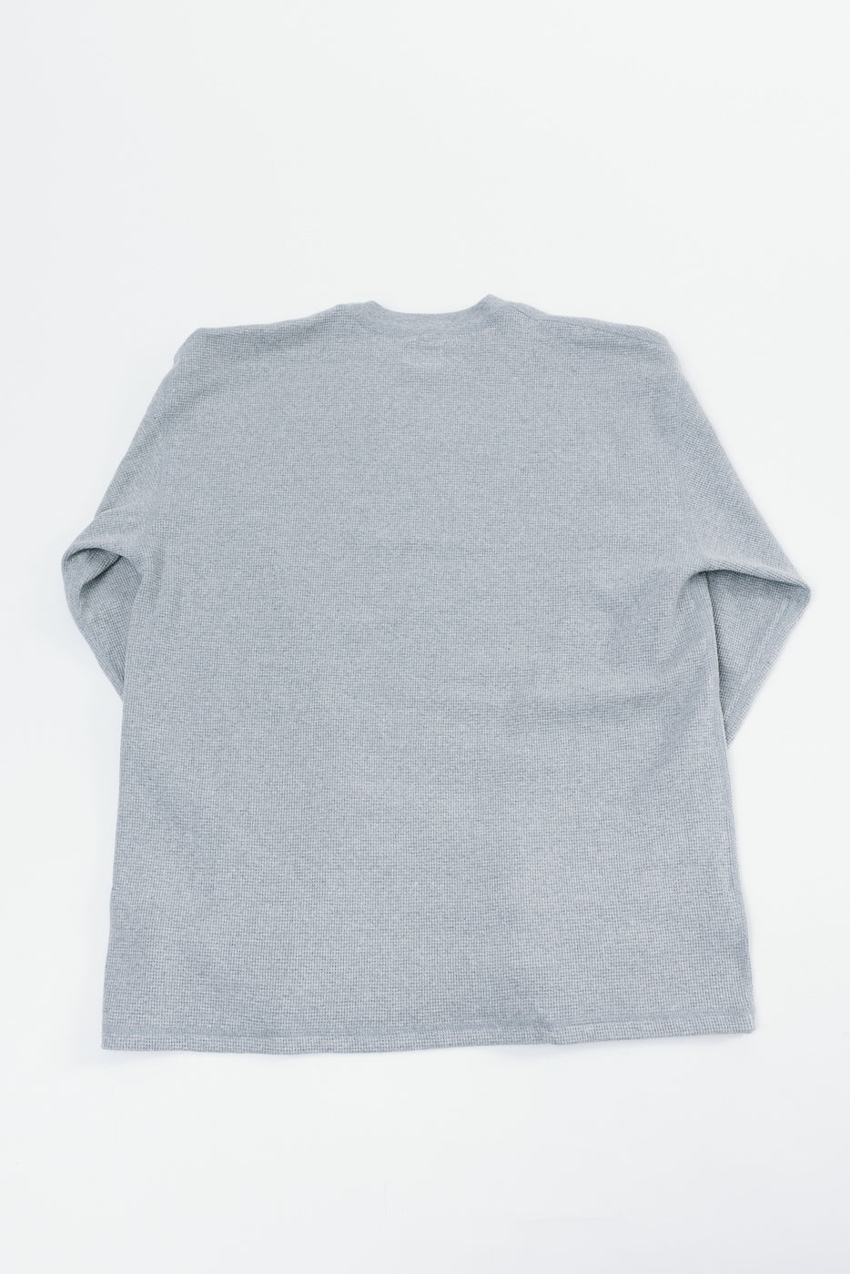Back view flat lay of a grey textured long sleeve crewneck shirt.