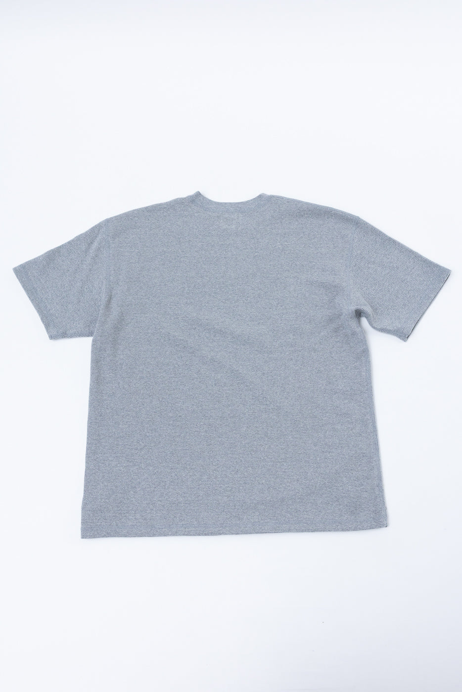 Flat lay showing the back of a grey textured short sleeve t-shirt.