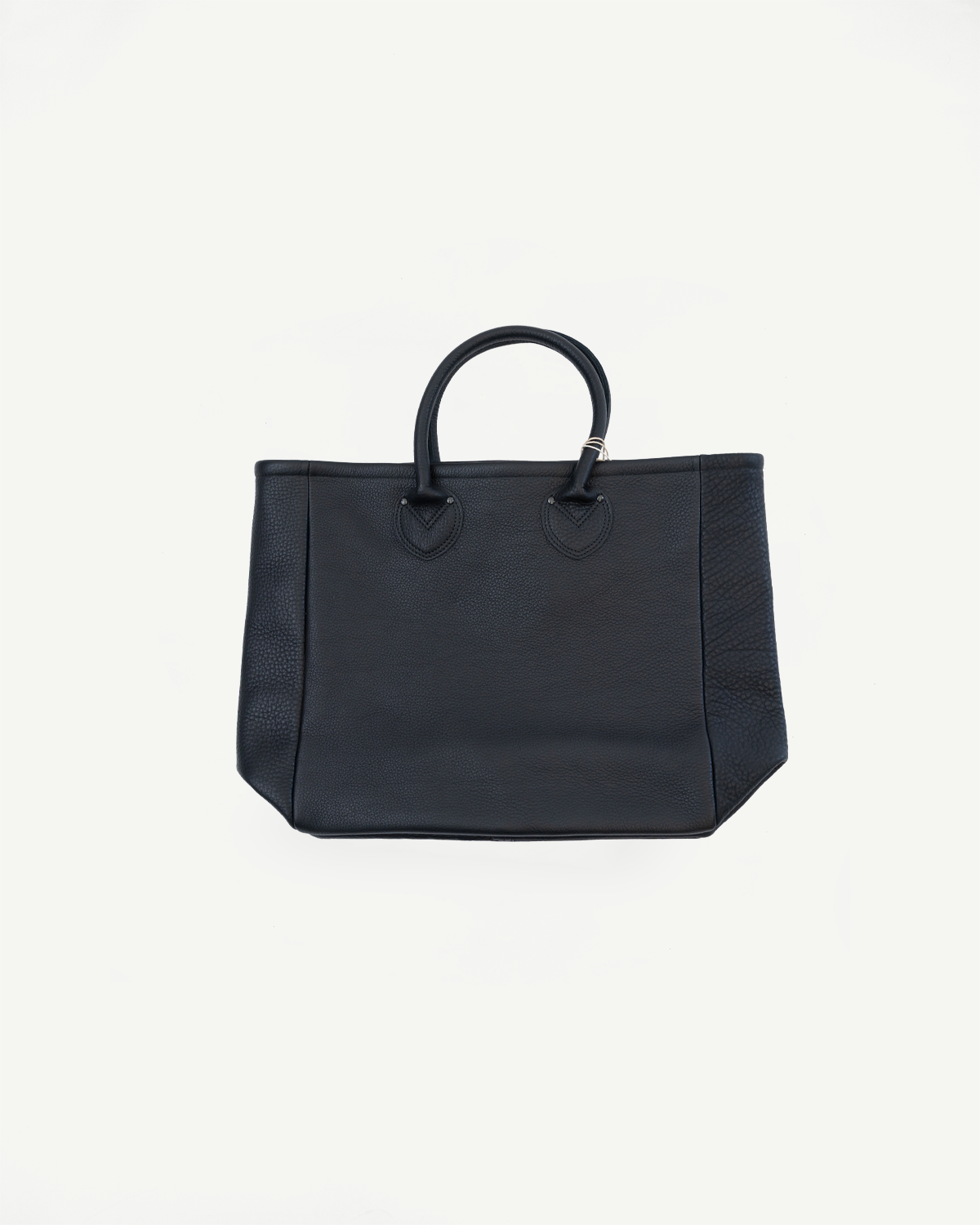 Front view of black pebbled leather tote bag with top handles and V-stitch detailing