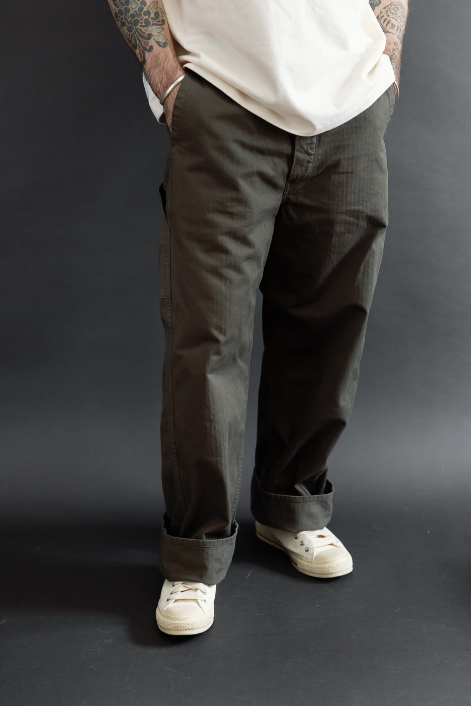 Front view of olive cargo pants on a male model (5'9