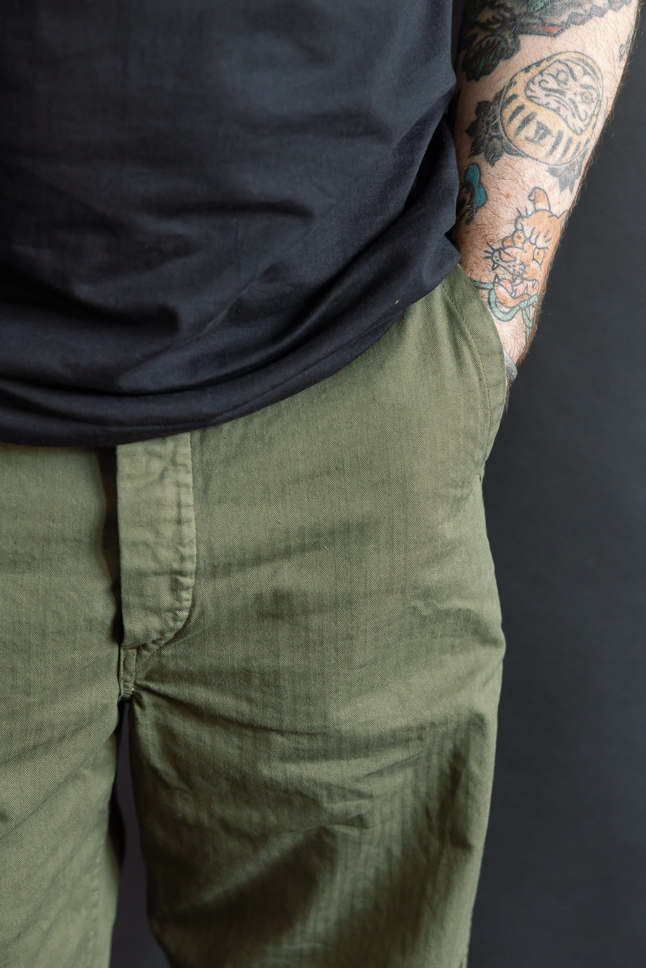 Close-up front view of army green work pant on male model, 5'9