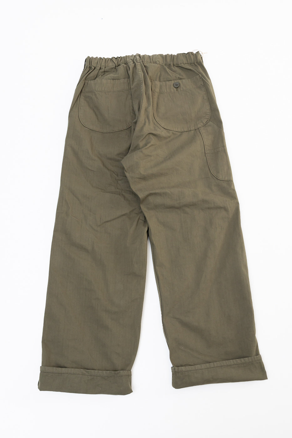 Back view flat lay of olive green wide-leg trousers with large patch pockets and cuffed hems.