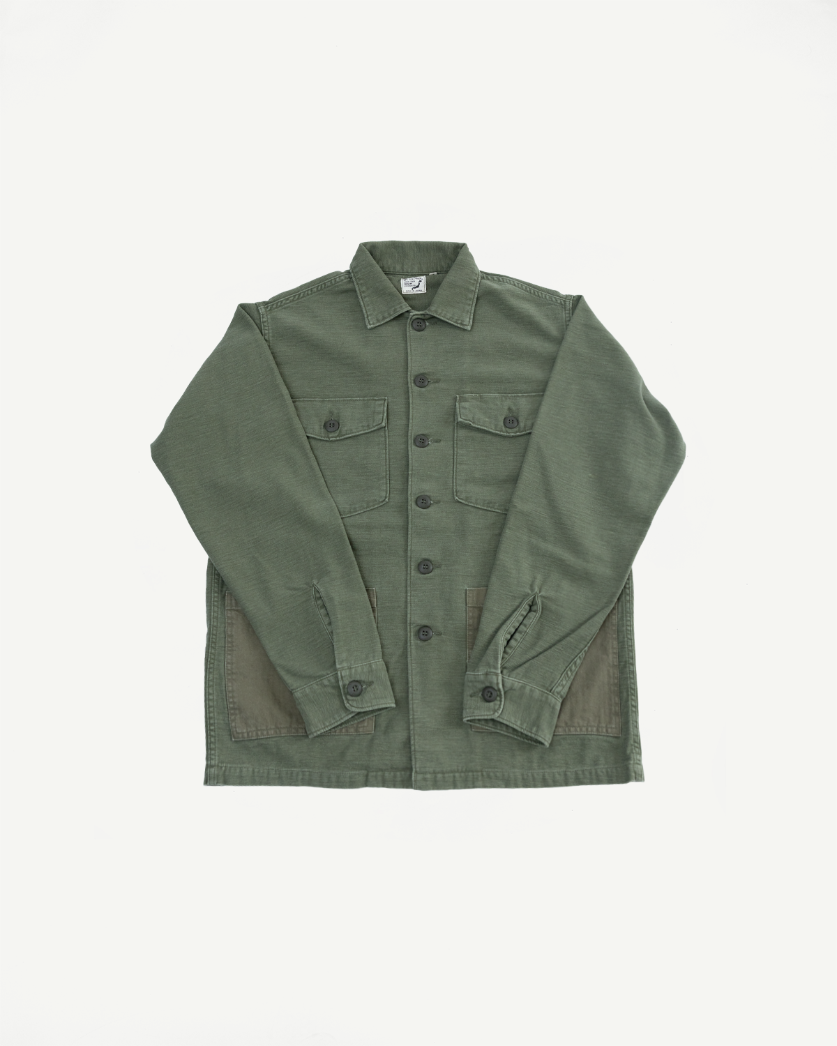 Flat lay, front view of orSlow 4-pocket fatigue shirt in dark olive reverse sateen, showing button details, collar, front chest and waist pockets. Contemporary casual apparel from Dant.