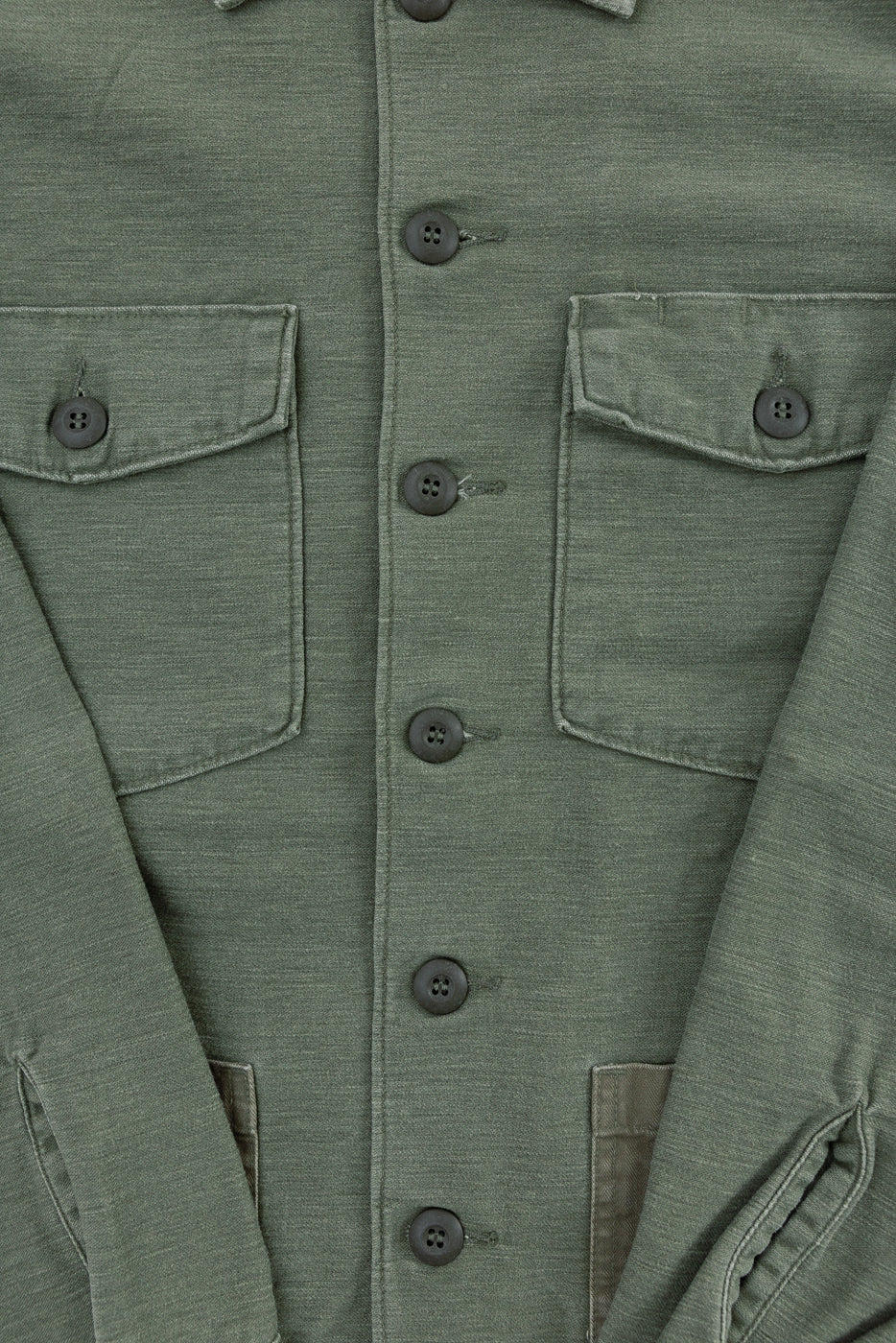 Close-up front of orSlow fatigue shirt in dark olive sateen, showing button details and chest pockets.