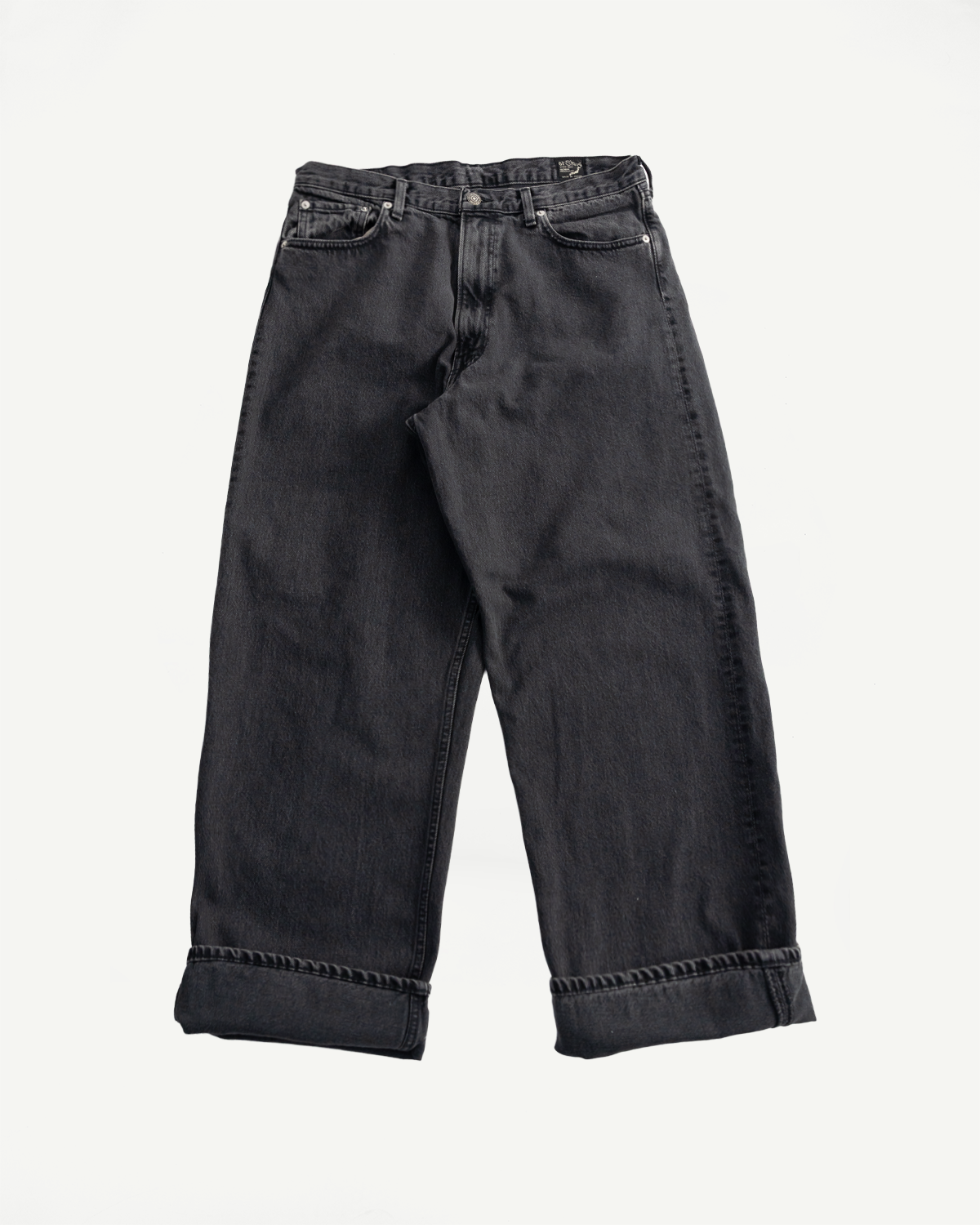 Flat lay front view of black denim Orslow jeans, cuffed hem, classic five-pocket style, Dant