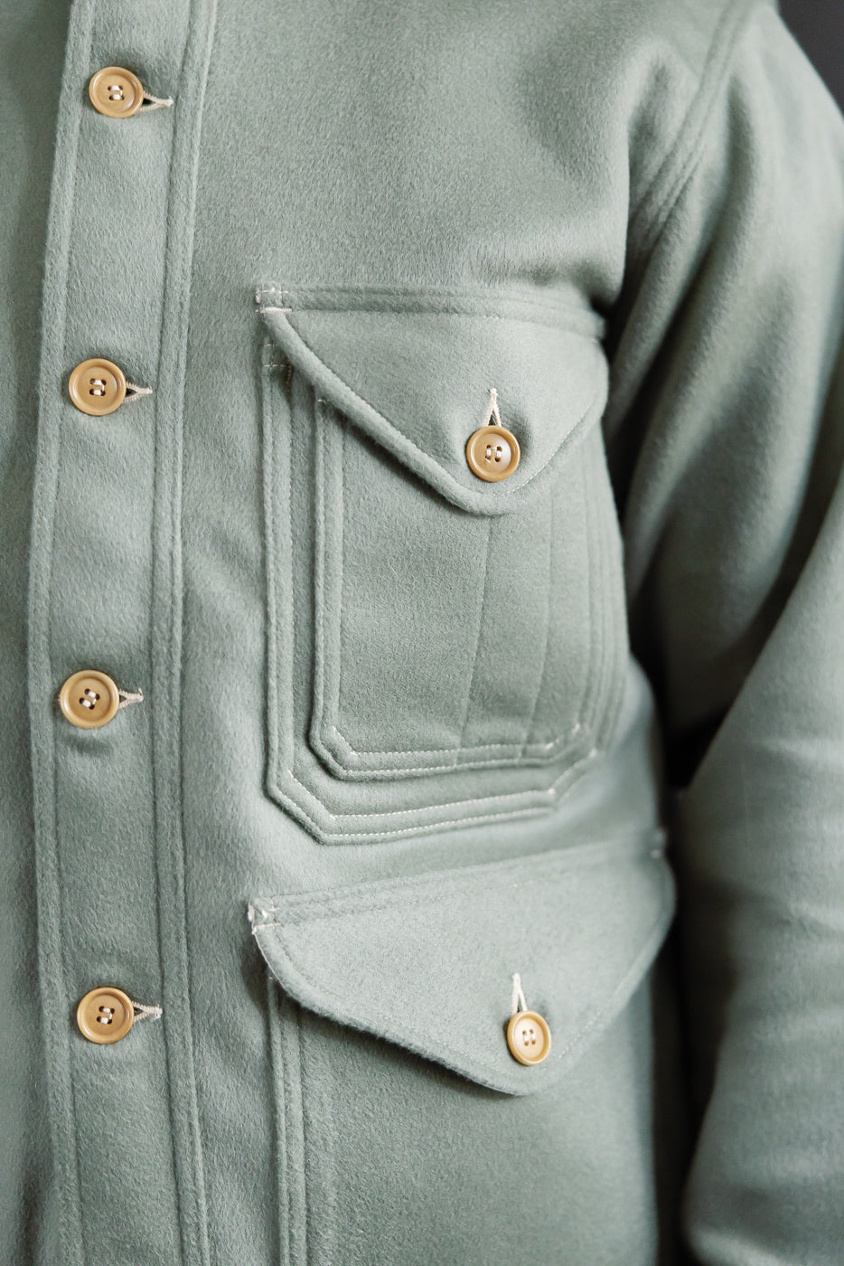 Close-up front view of Post O'Alls Cruzer 5-R beaver melton jacket pale green, showing left chest and lower pockets, button details, and soft wool texture.