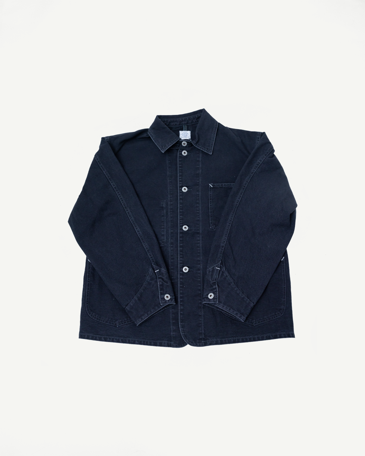 Flat lay front view of Post Overalls washed black canvas coverall jacket with button details