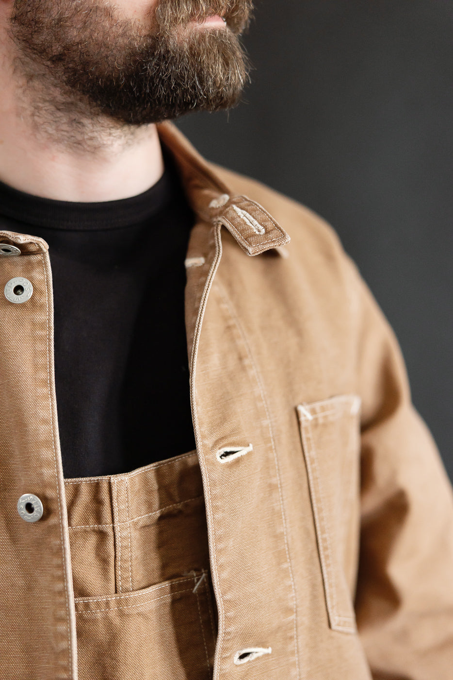 Close-up front of men's washed brown canvas coverall on 5'9