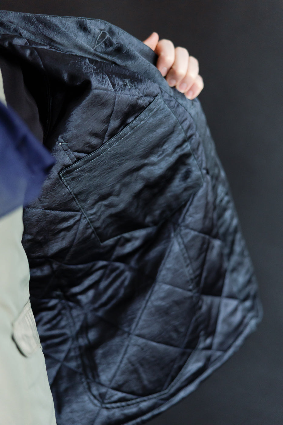 Close-up of inside left front of Post-Overalls quilted acetate sateen coverall, showing pocket.