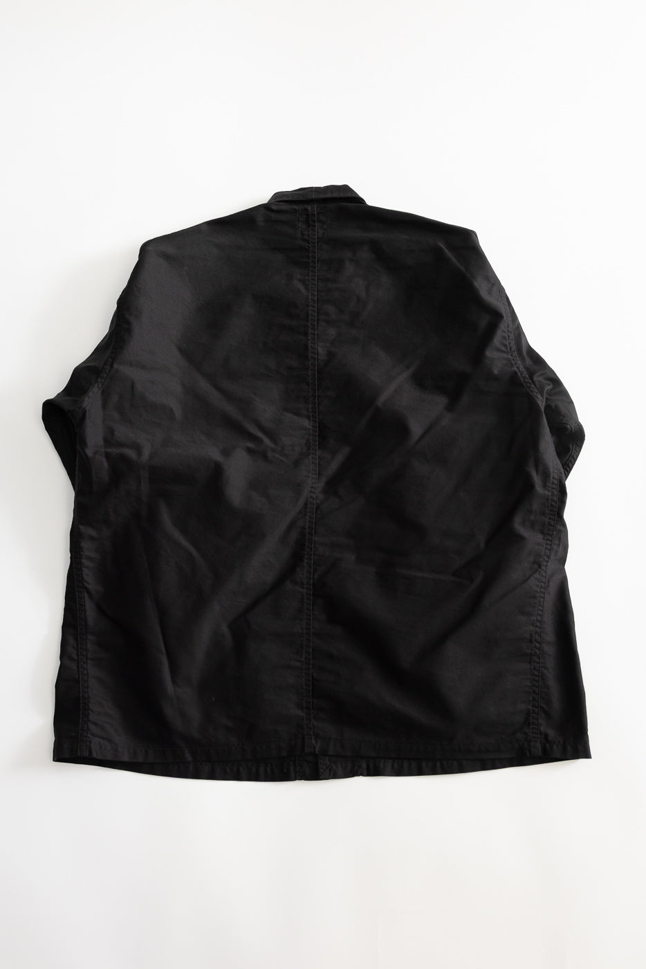 Flat lay of black light moleskin chore jacket, showing full back view and seam detail.