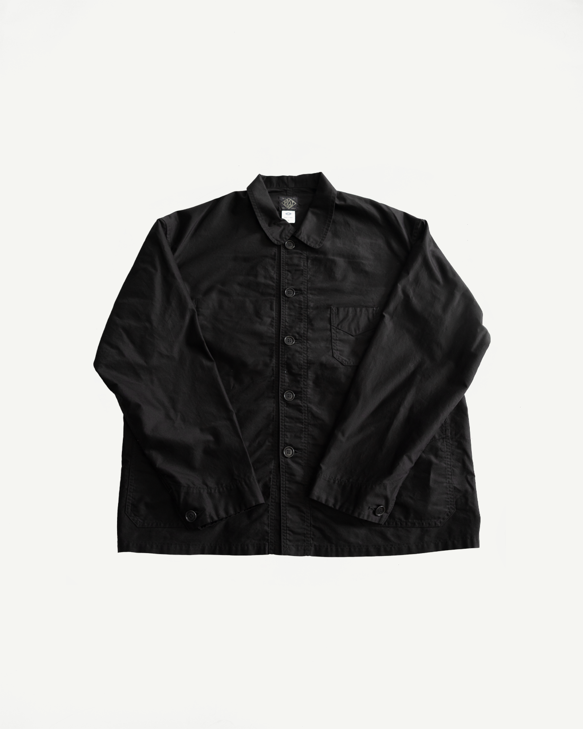 Flat lay, front view of black button-up work jacket with chest pocket, spread collar, cuffed sleeves.