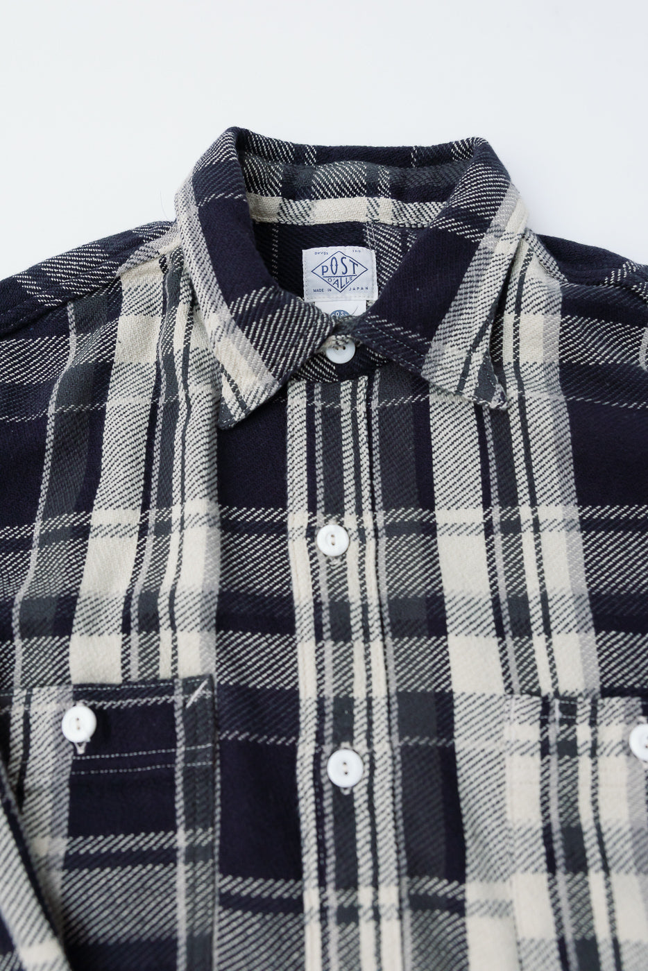 Close-up of front chest and collar on Post O’alls St. Louis grey plaid cotton flannel shirt, showcasing buttons, fabric texture, and chest pockets.