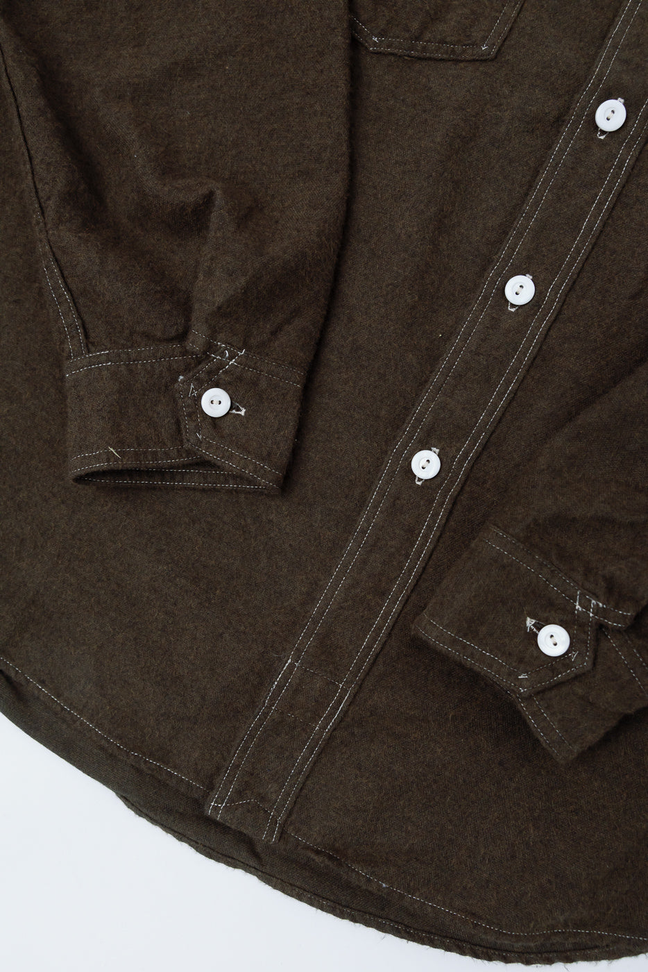 Close-up front of Post O’Alls St. Louis Band flannel shirt, cuffs, buttons, tobacco brown cotton.