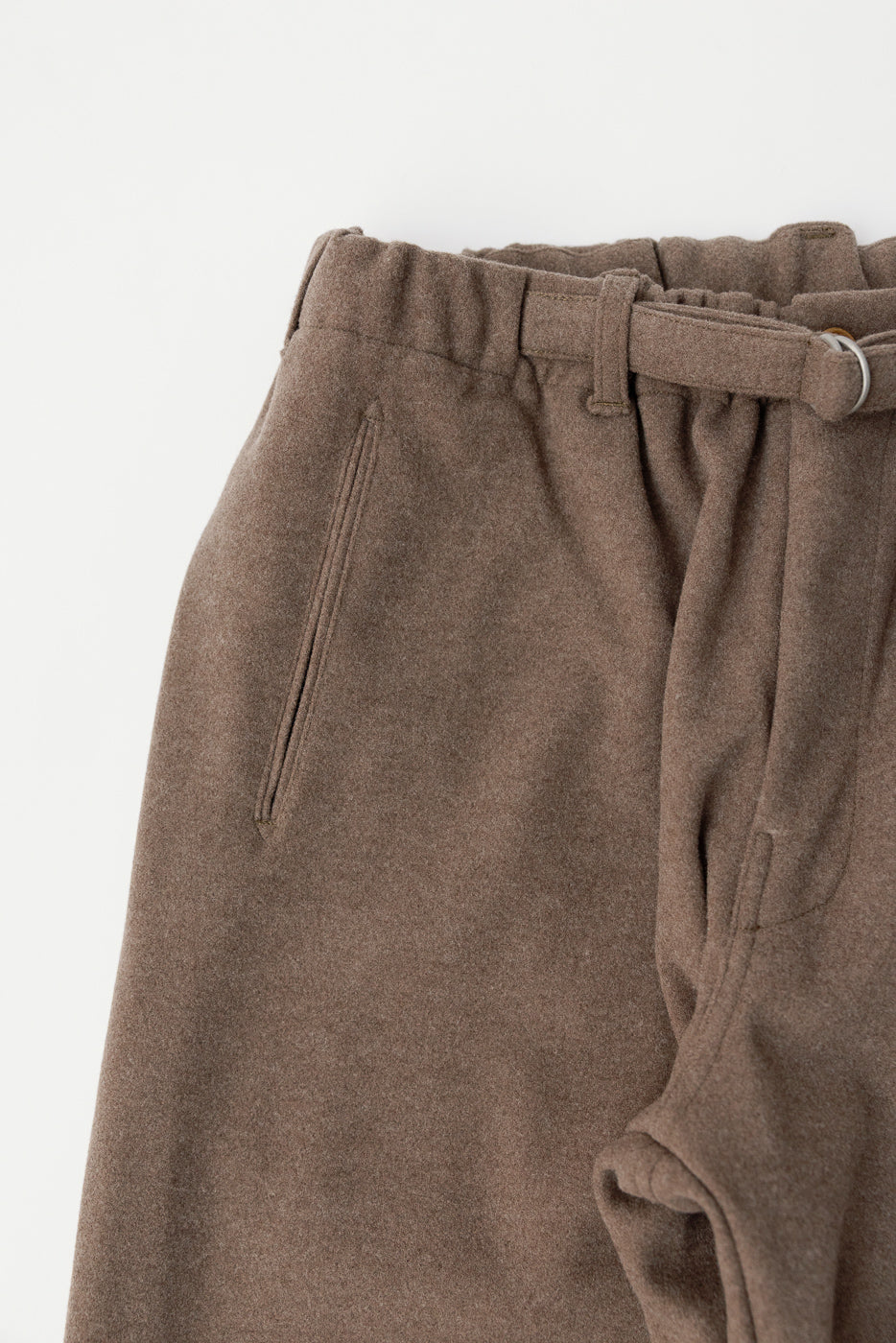 Close-up front view of brown Post Coach sweatpants, showing soft fabric, belt, and side pocket