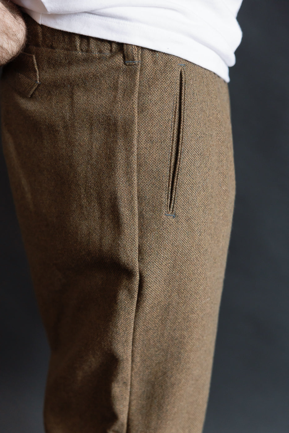 Close-up of side view, basket tweed brown pants on male model 5'9, 165lbs, athletic build