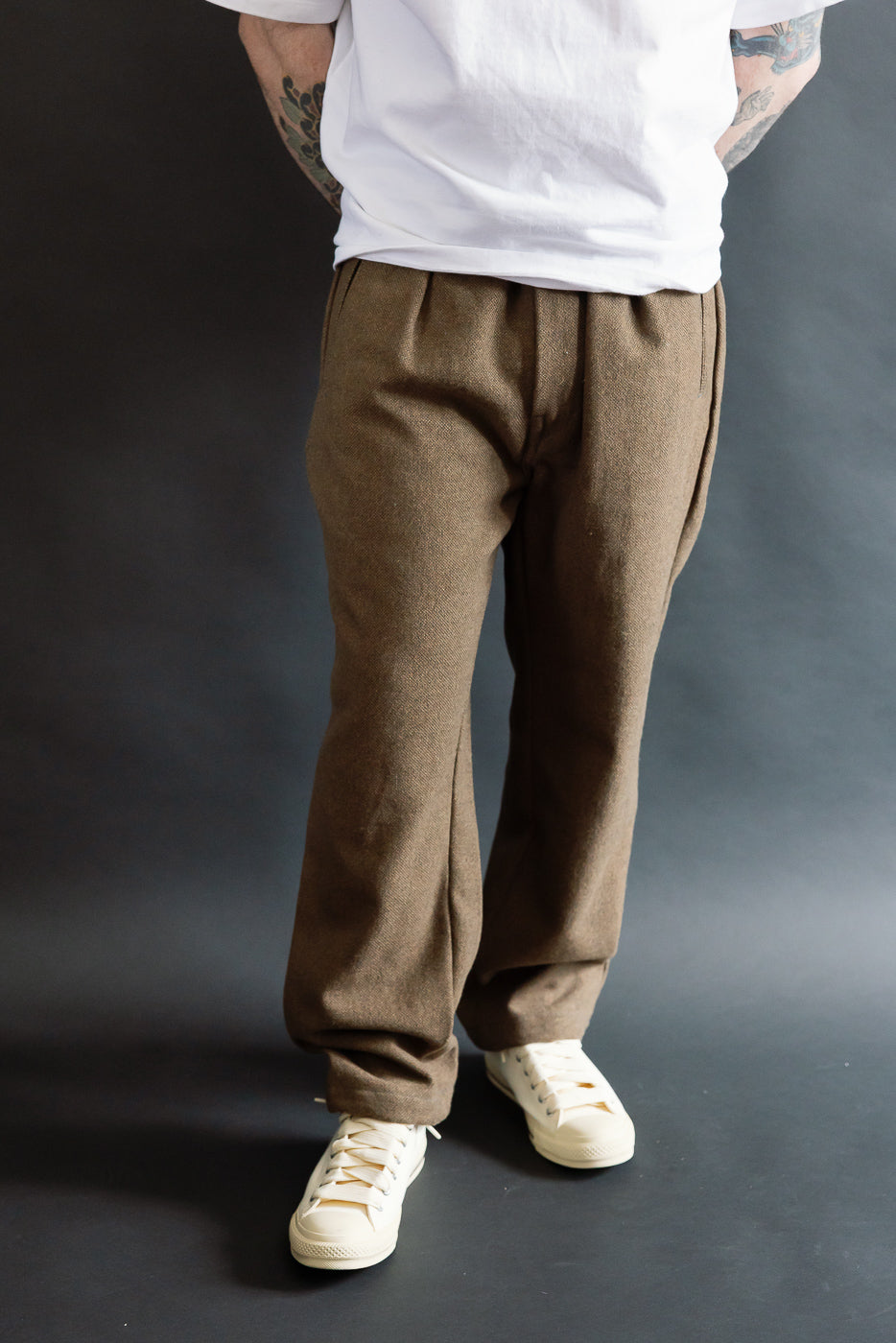 Front view, close-up of brown basket tweed pants on male model 5'9