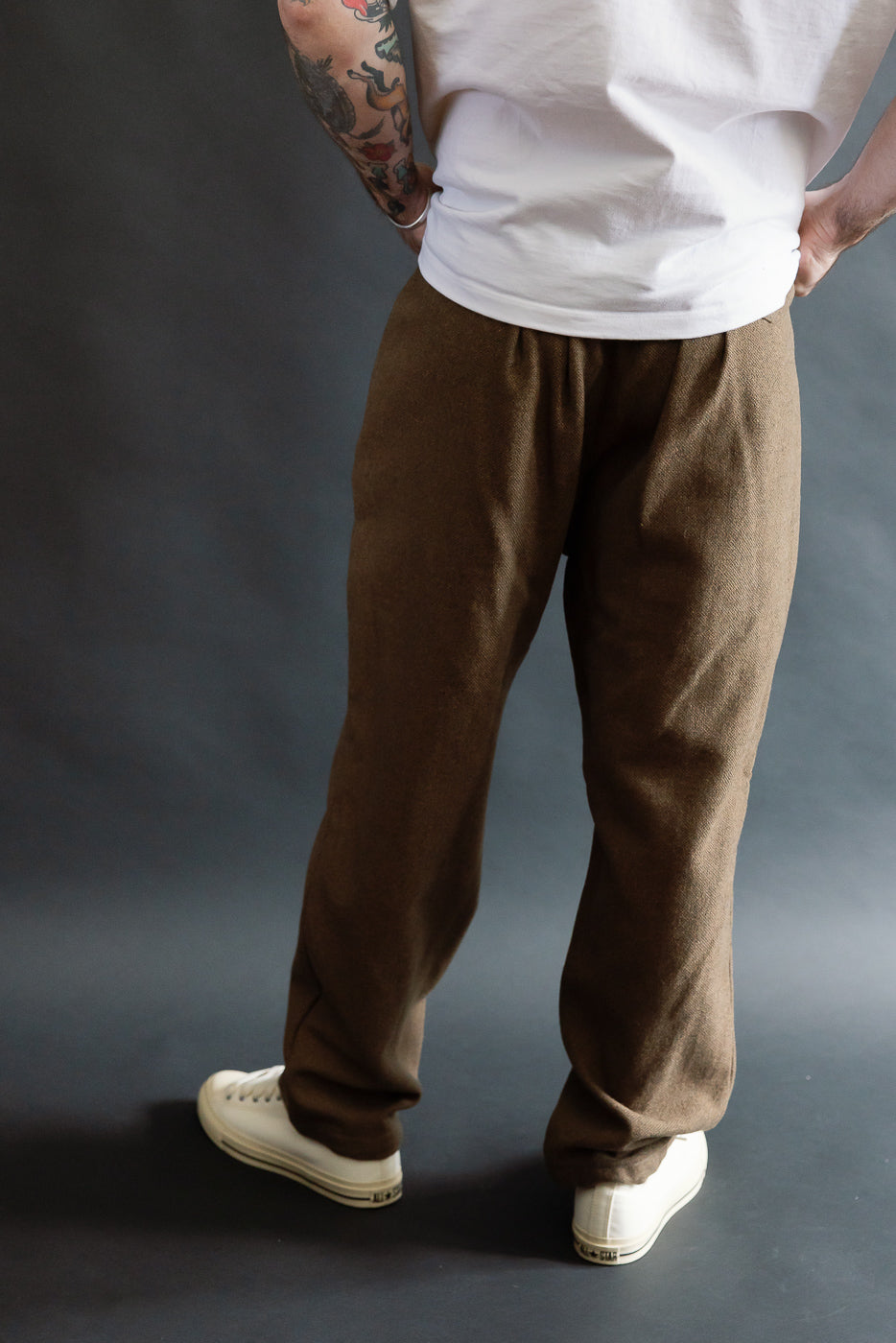 Back view close-up of brown basket tweed pants on male model, 5'9