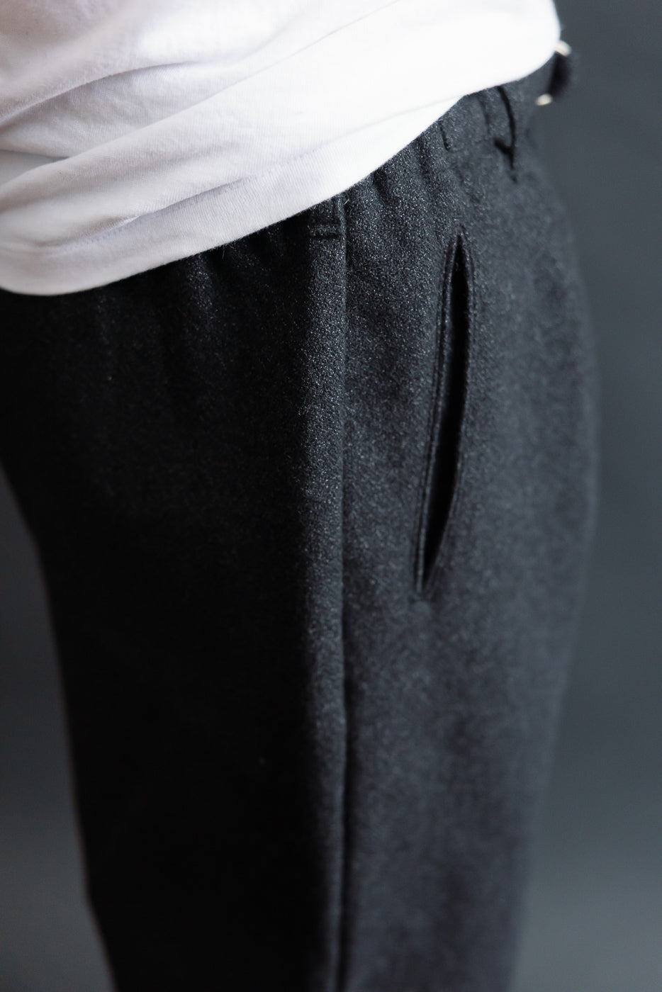 Close-up of men's charcoal basket tweed pants side pocket, athletic male model, Dant