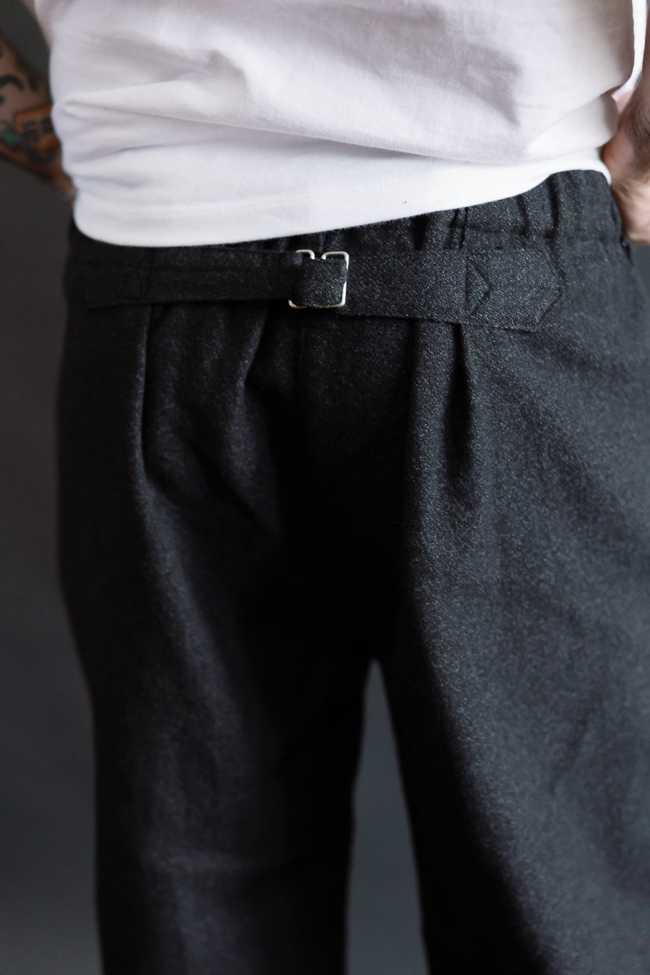 Close-up of back waist detail on men's charcoal basket tweed pants, male model, Dant