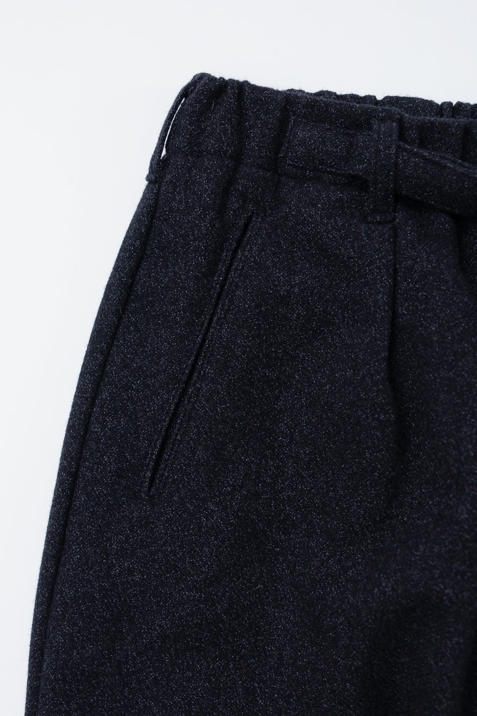 Close-up of front left pocket and waistband, charcoal basket tweed pants, detail view