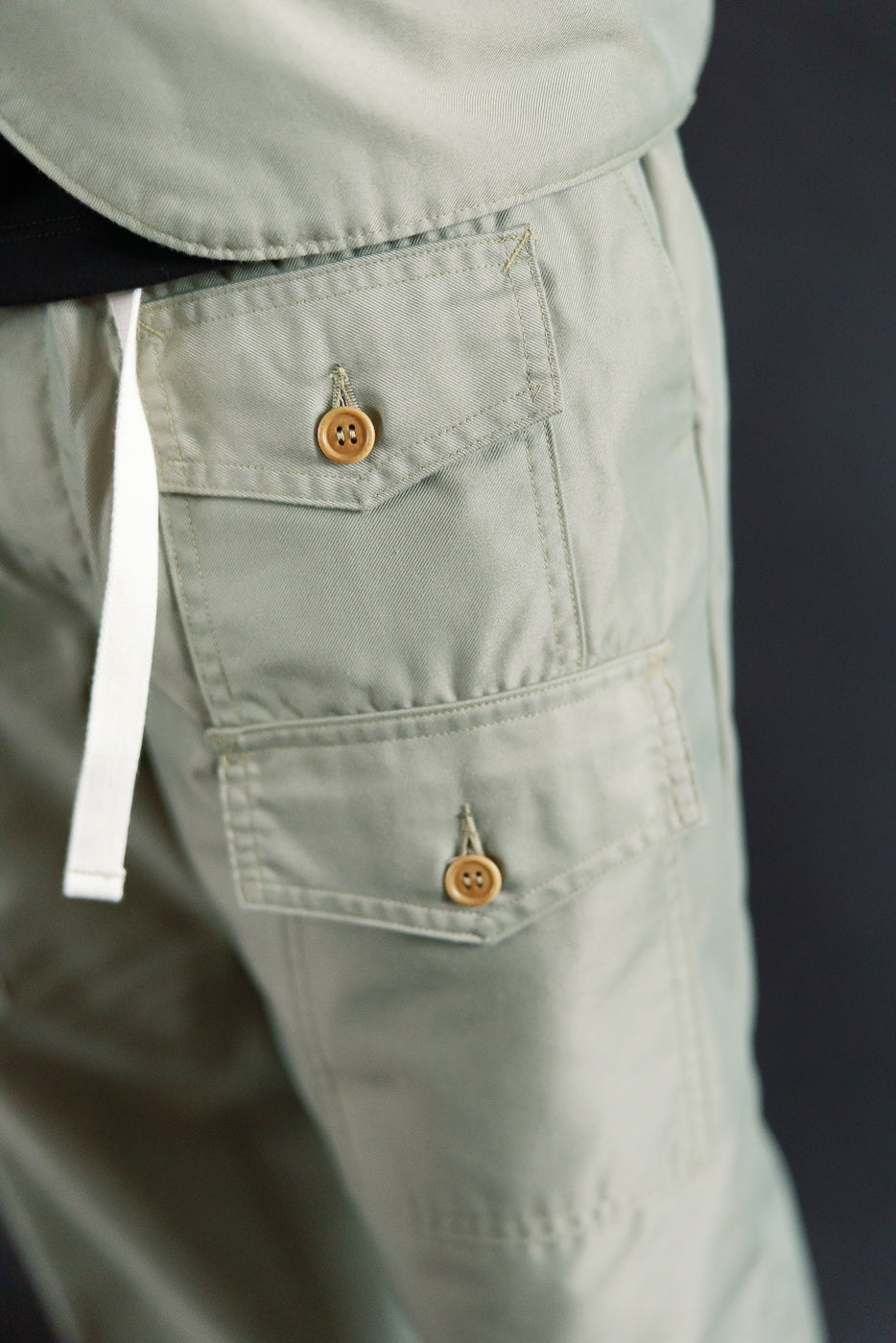 Close-up of Post O'Alls Town and Country khaki French twill pants side pocket, brown buttons, on male model 5'9
