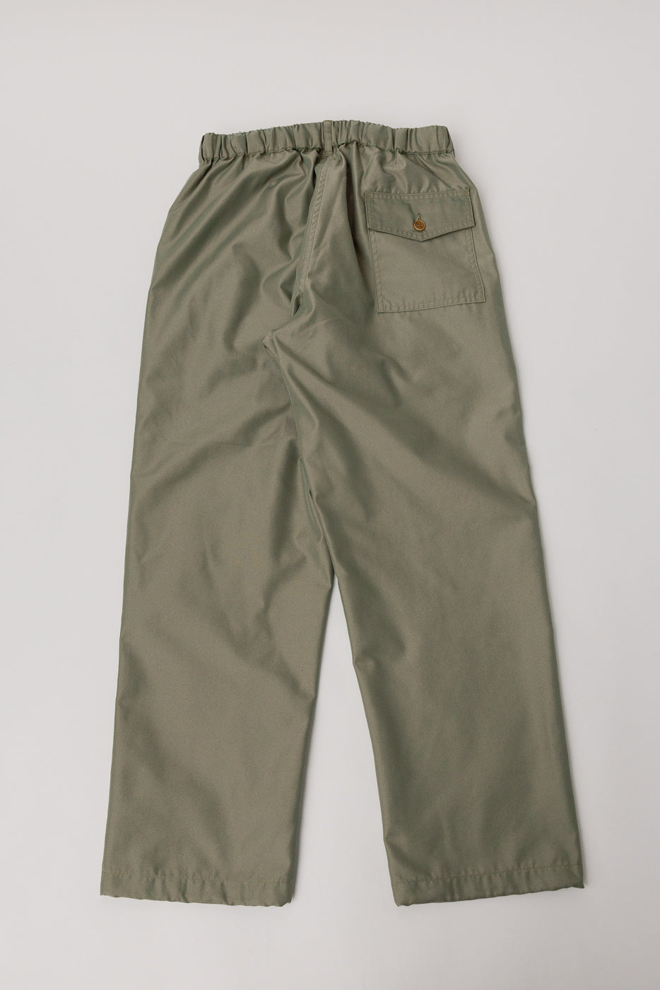 Flat lay of khaki Post O’Alls French twill pants, back view, with elastic waistband and buttoned pocket.