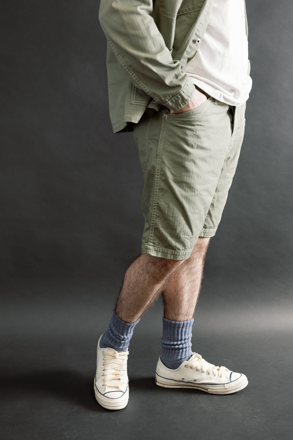 Side view close-up of sage green shorts on male model, 5'9