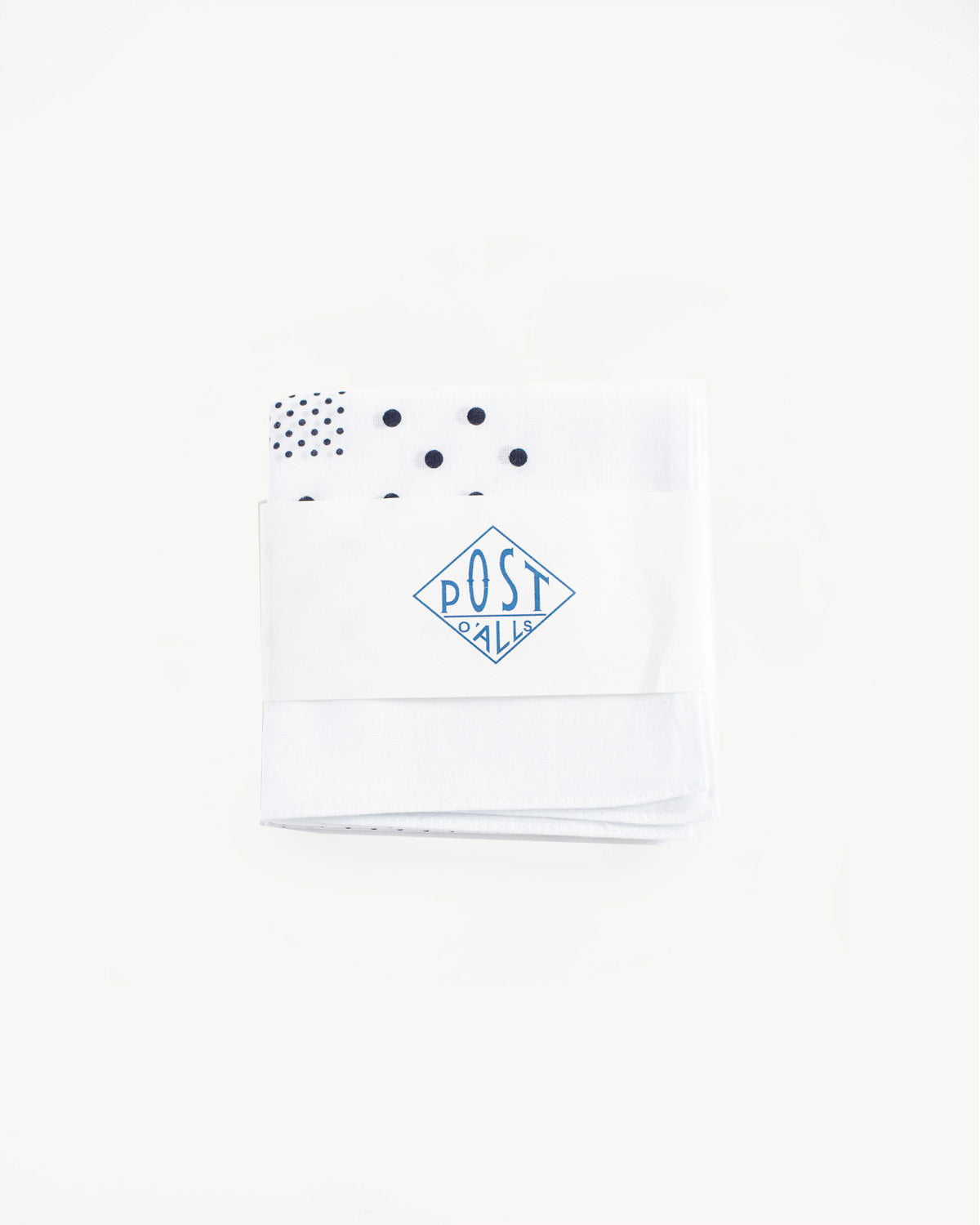 Front flat lay of white Post O’Alls bandana, polka dot print, folded in branded wrap.