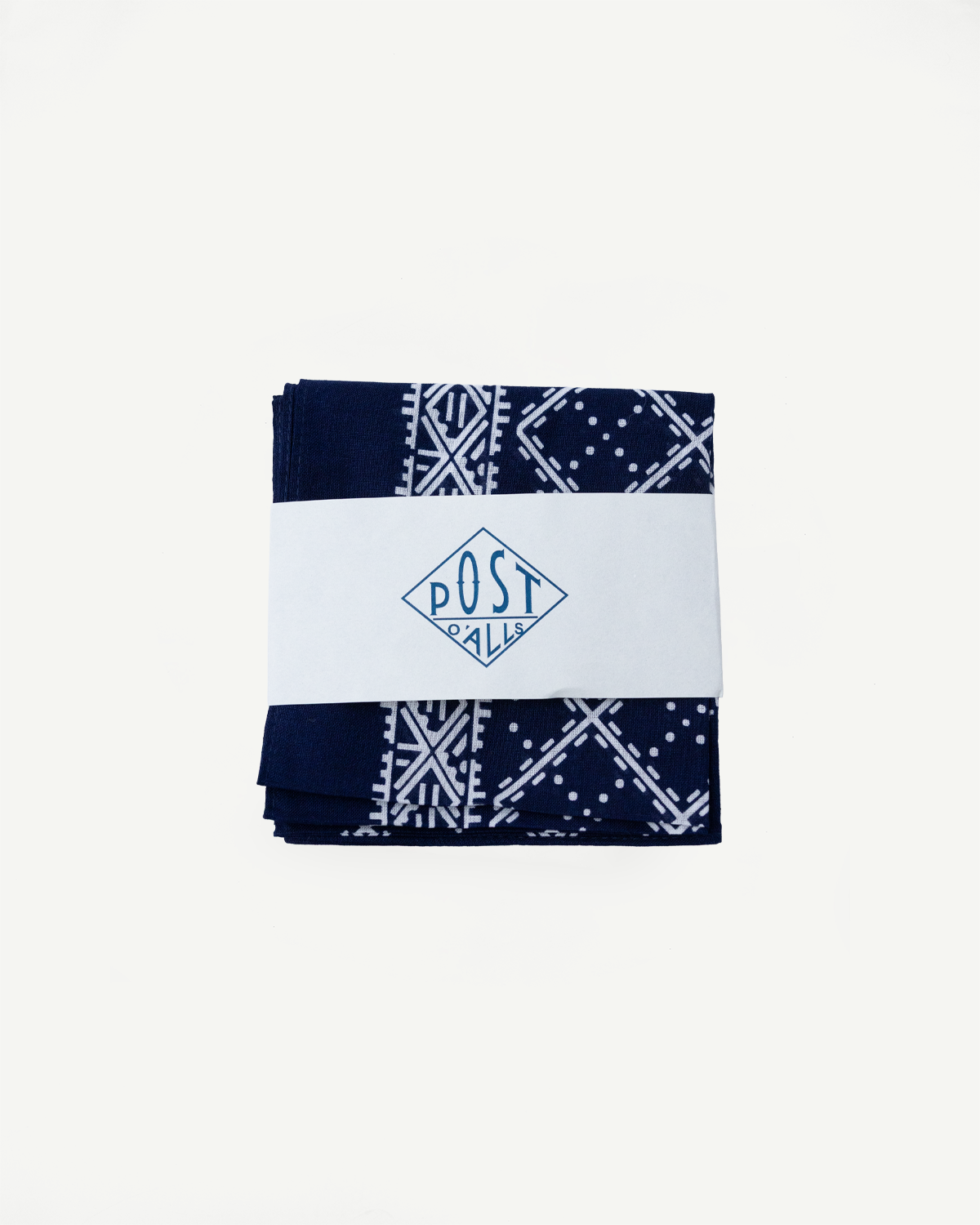 Folded navy bandana with white stitch pattern, front view, Post O’Alls packaging visible