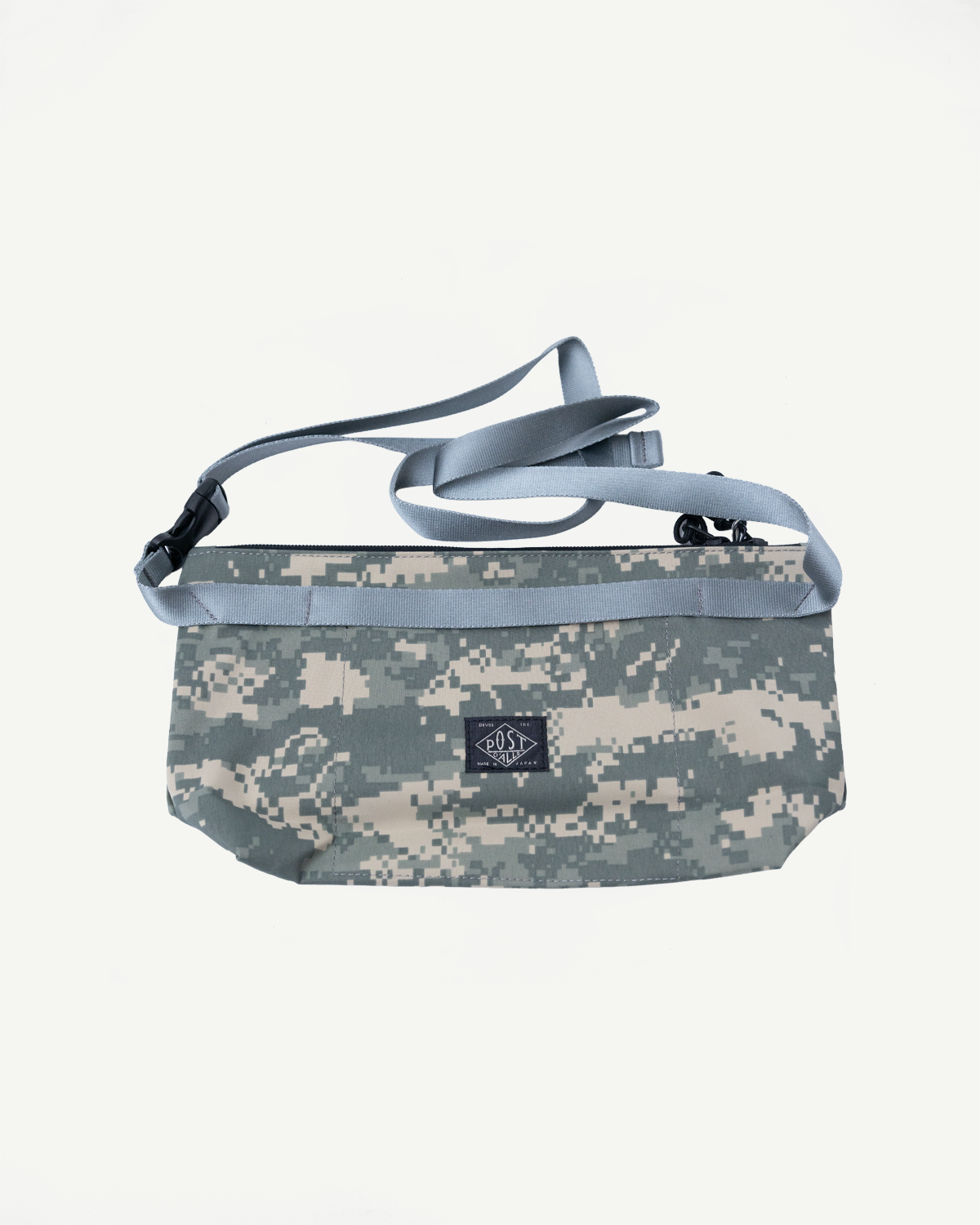 Front flat lay of Post O'Alls x Bagsinprogress fanny pack crossbody in desert digital camo with logo patch and adjustable strap.