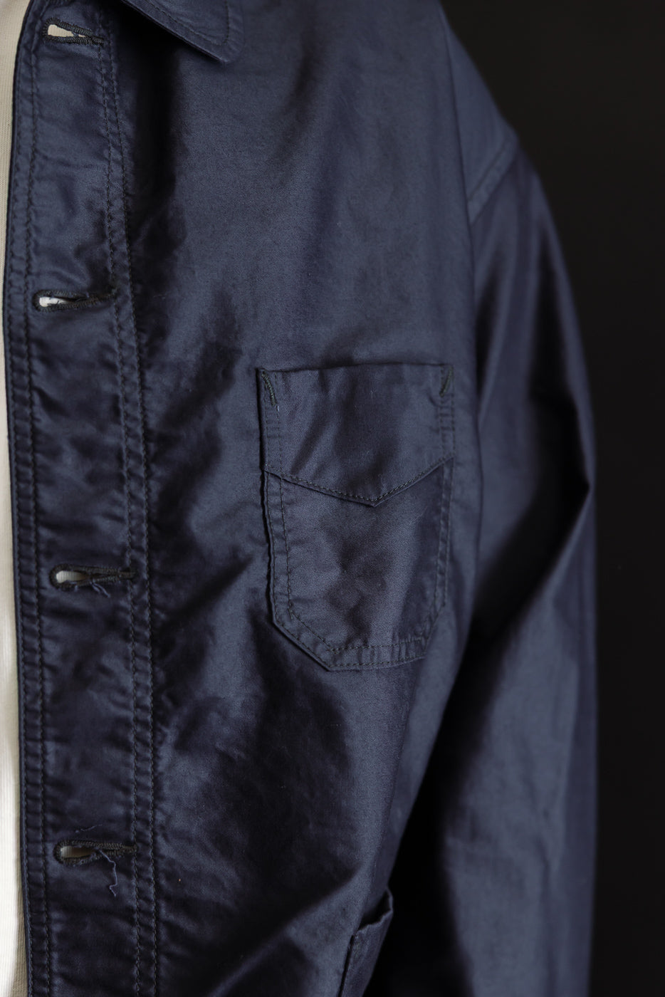 Close-up of the 3135-LMN - Post Chinois Travail 2 Light Moleskin jacket in dark navy, showcasing the textured cotton fabric, buttoned placket, and chest patch pocket, embodying a French-Chinese workwear fusion.