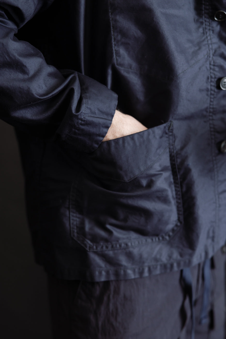 Close-up of the 3135-LMN - Post Chinois Travail 2 Light Moleskin jacket in dark navy, showcasing its flap patch pocket with a hand inserted, reflecting a blend of French-Chinese workwear influence.