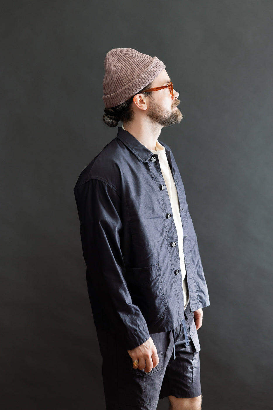 Side-profile of a man wearing the 3135-LMN - Post Chinois Travail 2 Light Moleskin jacket in dark navy, showcasing its cropped length, relaxed fit, and rounded collar.