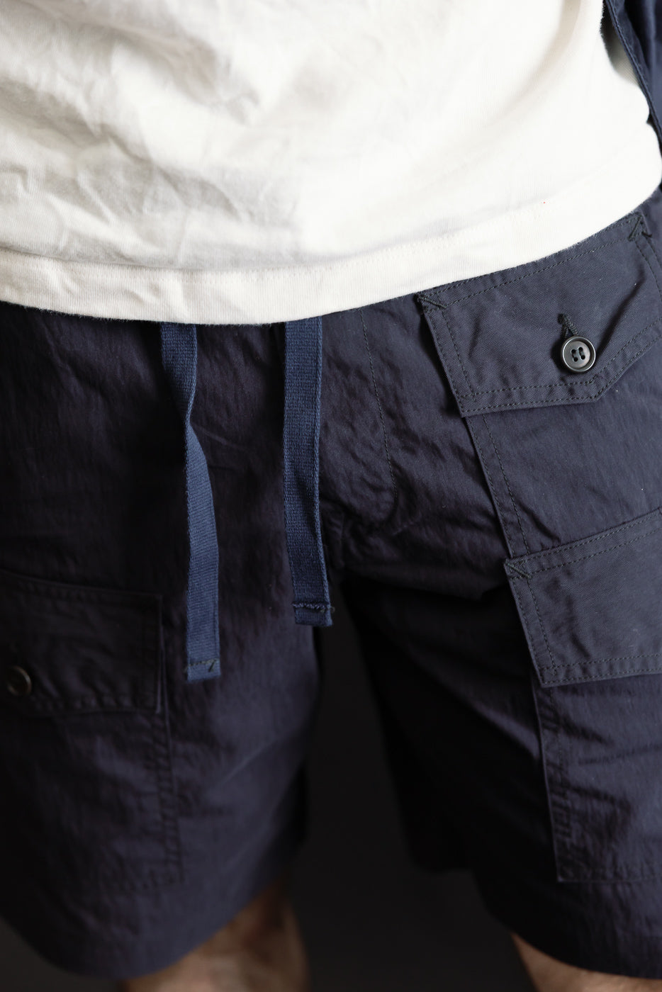 Close-up front view of navy 60/40 twill shorts on male model, 5'9