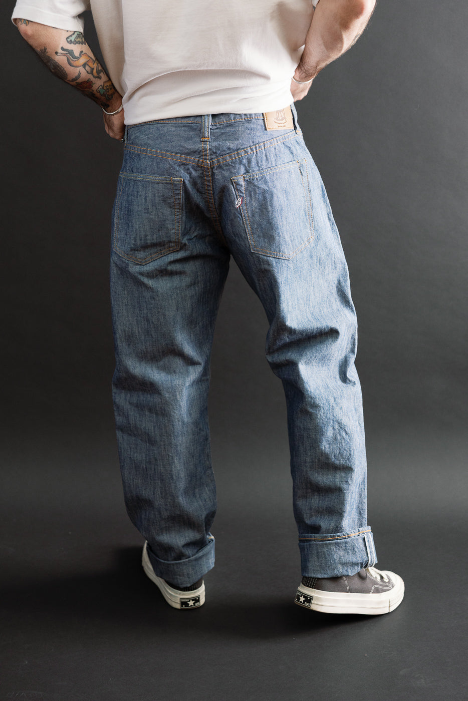 Full back view of blue denim jeans on a 5'9