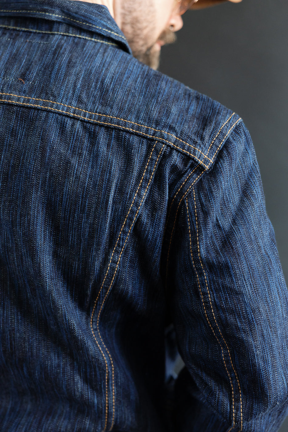 Close-up of the 6225-D - 14.5oz Dark Waterfall Selvedge Type 2 Jacket in Indigo, highlighting the detailed contrast stitching and textured Japanese selvedge slub denim on the shoulder and back.