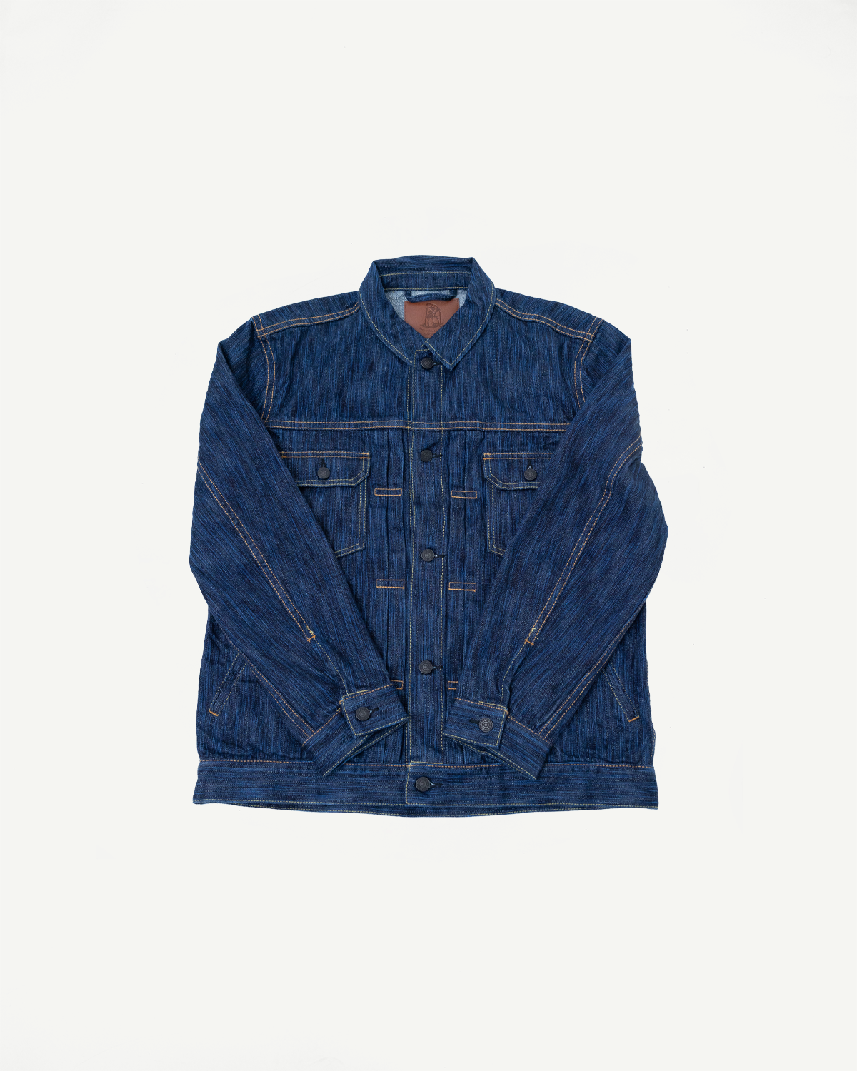 The 6225-D - 14.5oz Dark Waterfall Selvedge Type 2 Jacket - Indigo features a classic design with pointed collar, six-button placket, two chest pockets, and tan contrast stitching on blue denim.