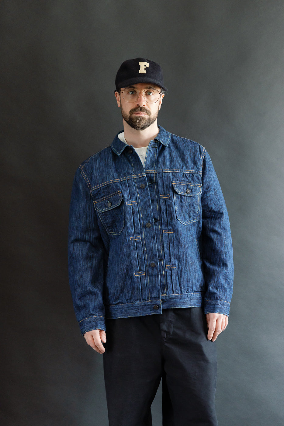 Model wearing the 6225-L - 14.5oz Light Waterfall Selvedge Type II Jacket - Indigo, showcasing its textured Japanese selvedge denim, chest flap pockets, and signature leaf embroidery, embodying heritage craftsmanship.