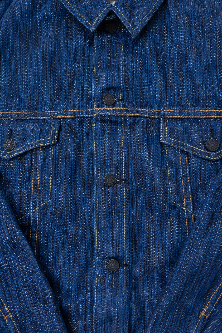 6226-L - 14.5oz Light Waterfall Selvedge Type III Jacket in Indigo features black metal shank buttons, flap chest pockets, golden-tan topstitching, and a subtle vertical striped weave, showcasing its structured Japanese selvedge denim design.