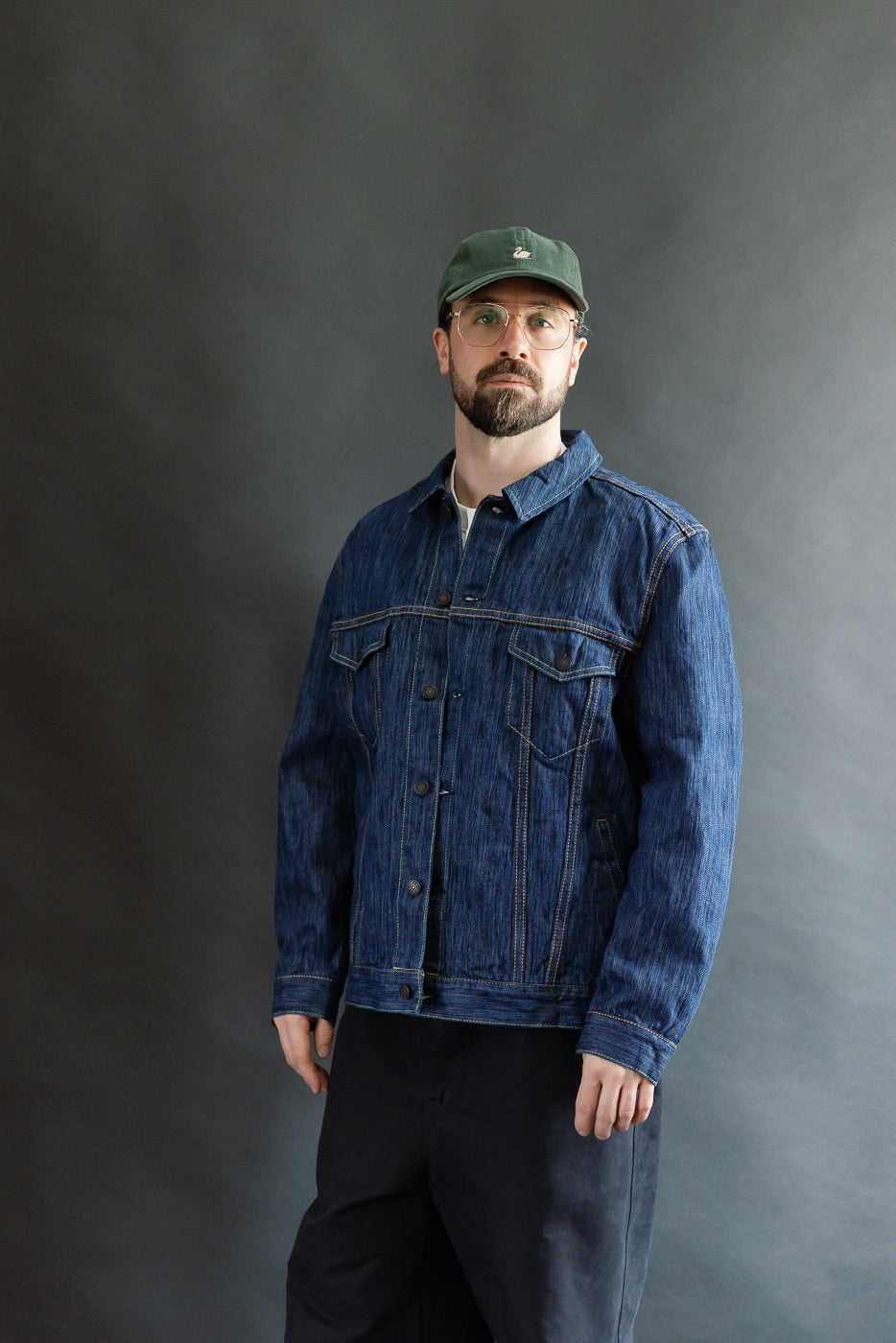 Adult male model wears the 6226-L - 14.5oz Light Waterfall Selvedge Type III Jacket. Showcases structured indigo denim with pointed flap pockets and signature leaf embroidery, reflecting Dant's premium menswear ethos.